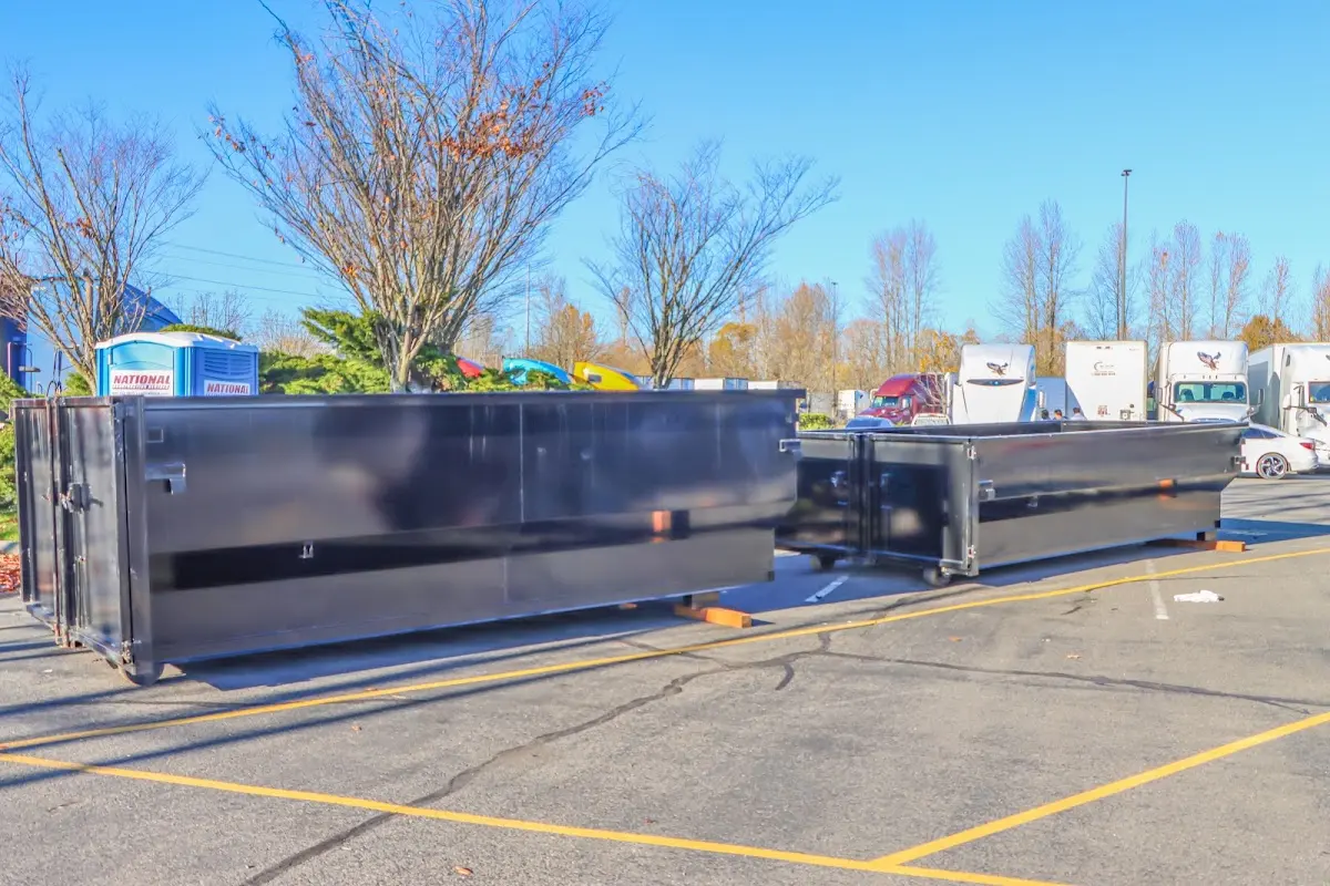 Professional dumpster rental service with roll-off container on residential driveway in Warrenton